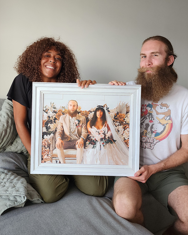 Couple holding custom wedding portrait painting